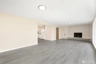 Large living room with cozy fireplace and updated flooring creates a clean, modern feel.