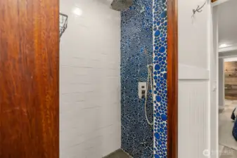 Primary bathroom shower has the coolest tile ever