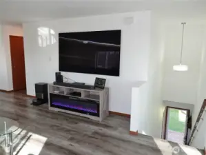 Stairs from the garage and back of the home lead up to the living area.