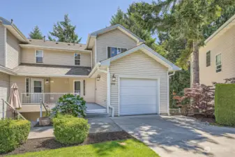 Front of home with 1 car garage + work area attached to the home via interior access.