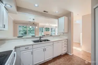 Kitchen with coffered ceilings and lots of natural and can style liting.