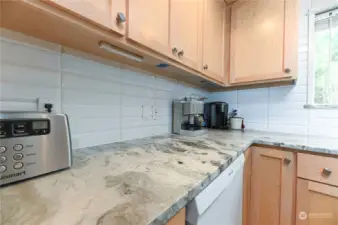 Granite counter tops and subway tile backsplash.