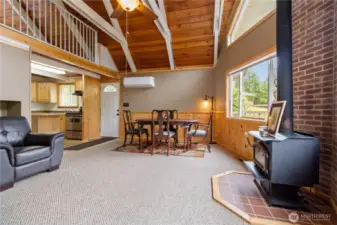 Great room with wood burning stove and tongue and groove cedar.