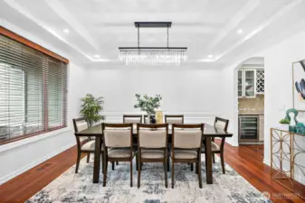 The formal dining area is very spacious with coffered ceilings with crown molding and recessed lighting.
