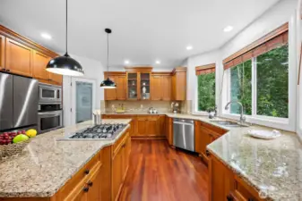 Some of the other kitchen features are a walk in pantry, ample cabinet and storage space, 5 burner gas stove, tile backsplash and undermount sink.