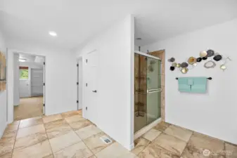The step in tiled shower has dual showerheads and controls.