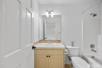 Bedroom 2 on the upper level features an en-suite bathroom.