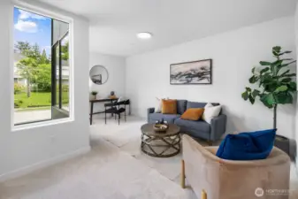 Flexible lower-level lounge or media room—perfect for movie nights, play space, or a roomy WFH setup. Photos are of model home 8825, finishes and floorplan may vary.