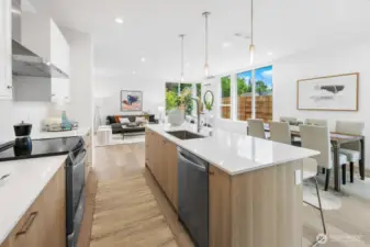 Dining zone sits between yard light and kitchen convenience—host with ease. Photos are of model home 8825, finishes and floorplan may vary.