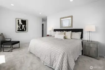 Large upper-level bedroom drenched in daylight; quiet carpet underfoot signals rest. Photos are of model home 8825, finishes and floorplan may vary.