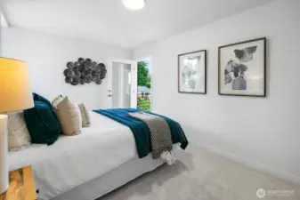 Bright secondary bedroom overlooking greenery; easy guest, office, or creative studio. Photos are of model home 8825, finishes and floorplan may vary.