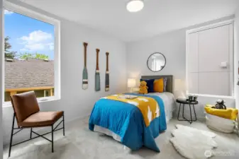 Playful bedroom styled with color and natural light—perfect for younger residents or guests. Photos are of model home 8825, finishes and floorplan may vary.