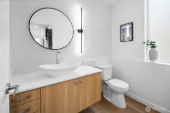 Chic powder bath showcases a floating vanity, vessel sink, and designer lighting. Photos are of model home 8825, finishes and floorplan may vary.