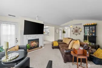 Living room has vaulted ceilings and fireplace