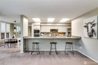 Built in entertaining bar meets the kitchen, and room for a sunny dinning space as well.