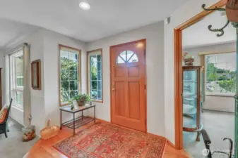 Welcoming entry with main floor bedroom/office to the right and spacious living rom to the left.
