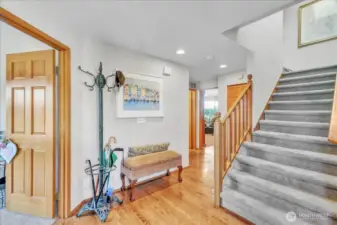 From the entry, head left to the laundry room, main half bath, and into the cozy family room and kitchen.