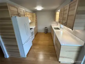 Unit A-updated kitchen in 2020 features new cabinets, updated appliances, quartz countertops, tile backsplash.