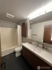 Unit A updated bathroom. Tile floors, updated vanity.
