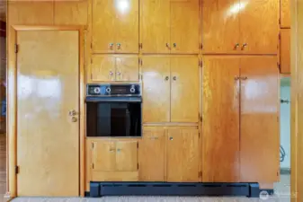Built in oven surrounded by a wall of of cabinet space! Door leads to the lower level.