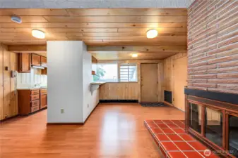 The half wall separates the kitchen from the living area.