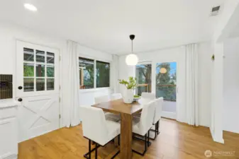 Dining room with large windows and open flow to the main living areas.