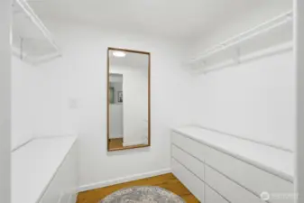 Walk-in closet with built-in shelving for organized storage.