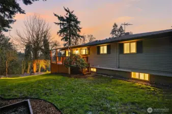 Side yard view of this two-level Kent home with mature landscaping and large lot.