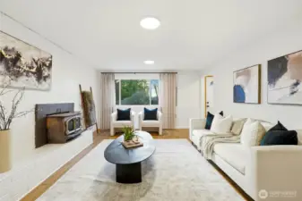 Bright lower-level family room with large window and open layout, ideal for flexible living space.