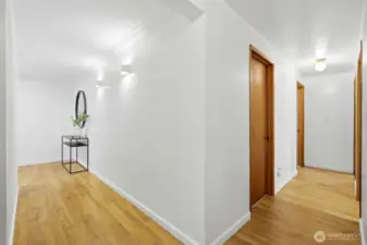 Lower-level hallway connecting bedrooms and living spaces with updated flooring.