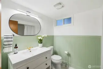 Updated lower-level bathroom with modern vanity and clean finishes.