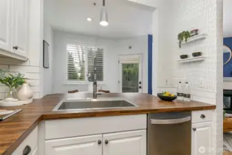 Stainless farmhouse sink is deep for functional use.
