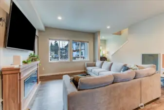 Great room with recessed lighting and the same laminate vinyl flooring throughout.  Large picture windows face the east and bring in the morning sunlight.