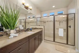 Primary Ensuite Bath Featuring a Spacious Double Shower with Built-In Seating.