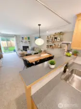 Kitchen space looking into living room.  Photo has been enhanced to better showcase the space