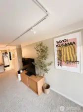 Looking back into living room towards kitchen.  Photo has been enhanced to better showcase the space.