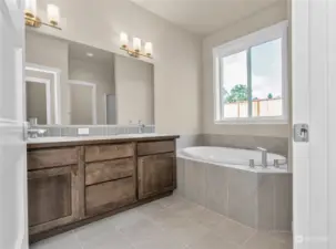 Primary bath with tile flooring and hard surface counters. Photo for illustration only, not actual