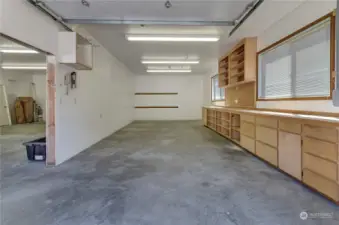 Inside of garage/shop with built in shelves and cabinets!