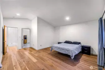Wide plank floors and lounge area enhance this relaxing upper-level layout.