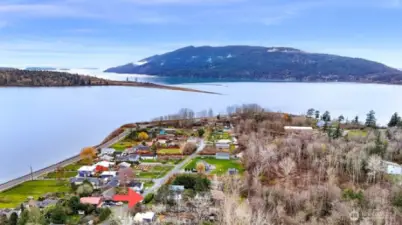 Aerial view highlights the home’s peaceful location with easy access to Bellingham and natural shoreline beauty.