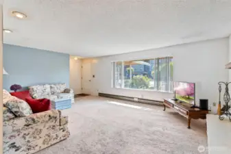 Standing in dining room looking into living room and entry of home