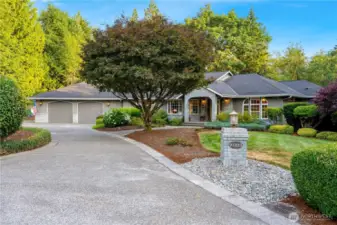 Immaculate curb appeal at 21223 SE 215th St, Maple Valley WA—nestled on a lush, private lot in the sought-after 98038 zip code with mature landscaping and a grand entrance.