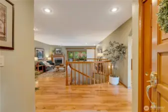 Welcoming foyer with gleaming hardwoods and bright lighting creates an inviting first impression in this 98038 property.