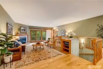 Spacious living room with fireplace and large windows, perfect for cozy nights or entertaining in Maple Valley.