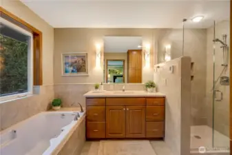 Luxurious primary bath with heat floors, soaking tub, dual vanities, and natural light—spa-like comfort in the heart of Maple Valley.