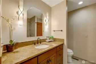 Main floor powder room with custom cabinetry and stylish finishes—designed for both beauty and function.