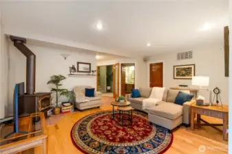Open-concept living space with hardwood floors, custom finishes, and warm natural light—perfect for everyday comfort in this Maple Valley home.
