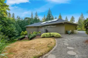 Side walkway with stone pathway and natural landscaping—adds privacy and convenience to this Maple Valley home.