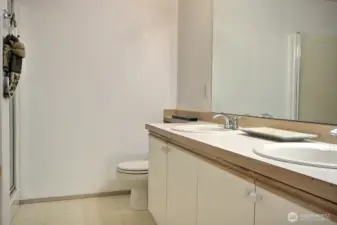 The Primary Suite w/ soaking tub, walk-in shower &  2-sink vanity.