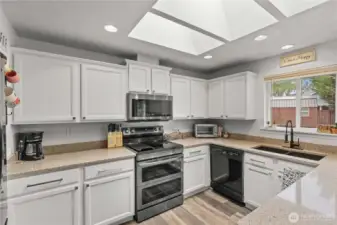 Kitchen showing off the natural light from three skylights above.